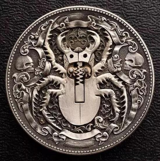Mechanical beetle coin with engraved details and hidden golden body revealed when the wings open