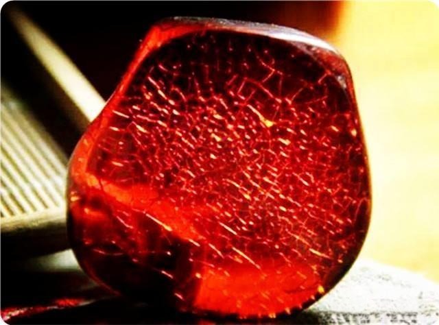 Close-up of natural Burmese blood amber showing its unique weathering patterns and textures, highlighting authentic aging in untreated amber.