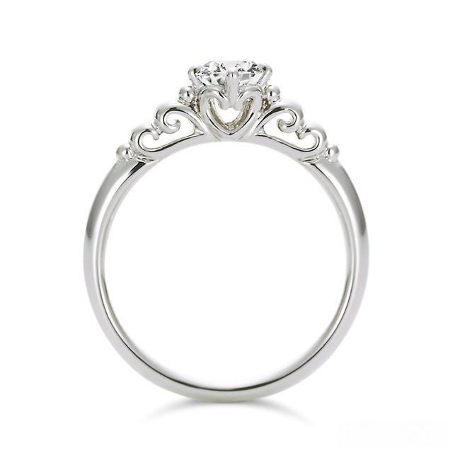 A diamond ring with a carved band, showcasing a personalized, engraved design that adds a special, individual touch to the piece.