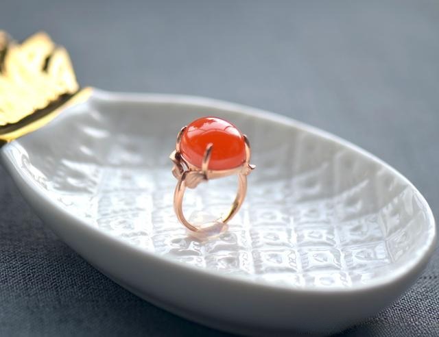 South-Red Agate ring after jewelry redesign, with sleek elevated bezel and sculptural lines, highlighting natural color and form.