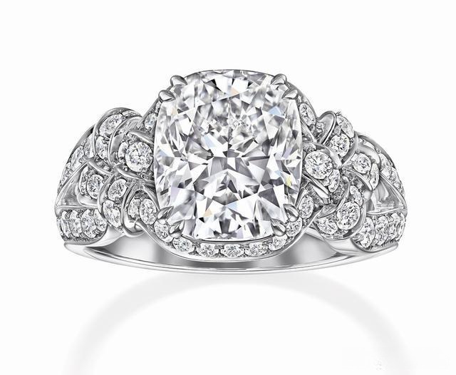 A tapered band ring featuring diamonds, creating a sleek, elegant design that accentuates the center stone with added sparkle and sophistication.