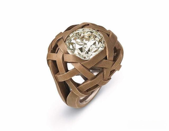 A custom diamond ring featuring a woven pattern design, combining intricate metalwork with personalized details for a unique and elegant look.