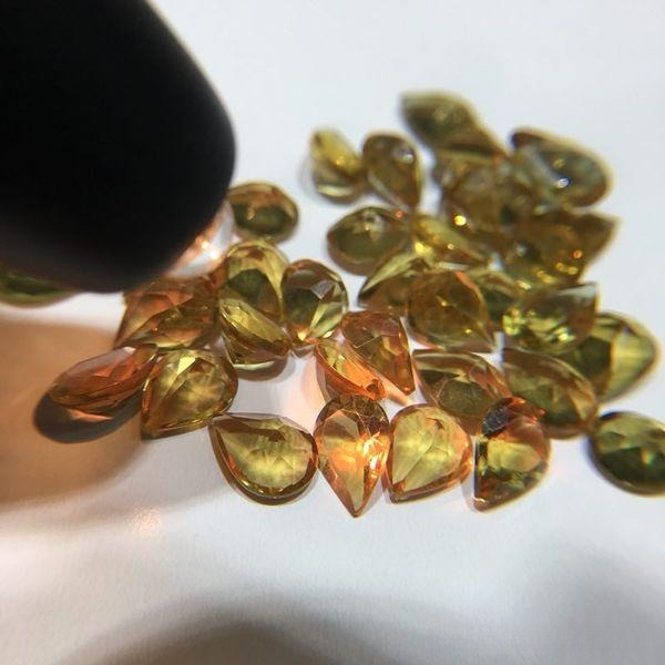 Glass stone with color-change effect, created by adding rare earth elements to imitate alexandrite under different light sources.