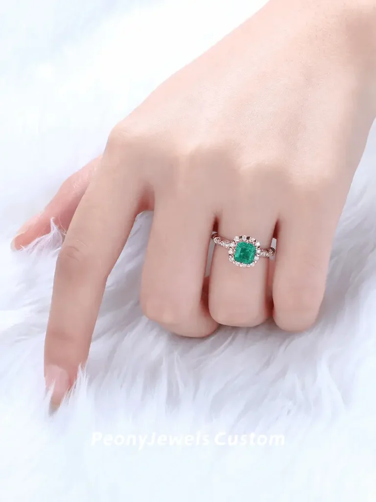 A custom-designed 1-carat natural emerald and diamond ring set in 18K yellow gold, accompanied by an official gemological certificate.