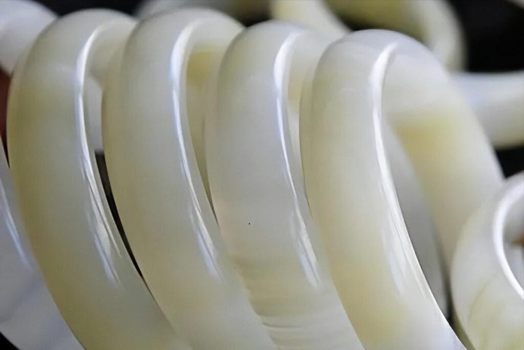 Afghan white jade bangles under magnification, clearly showing a distinct granular structure.