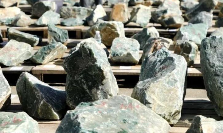 Rough African Jade stone showing natural green and floating patterns before cutting or polishing.