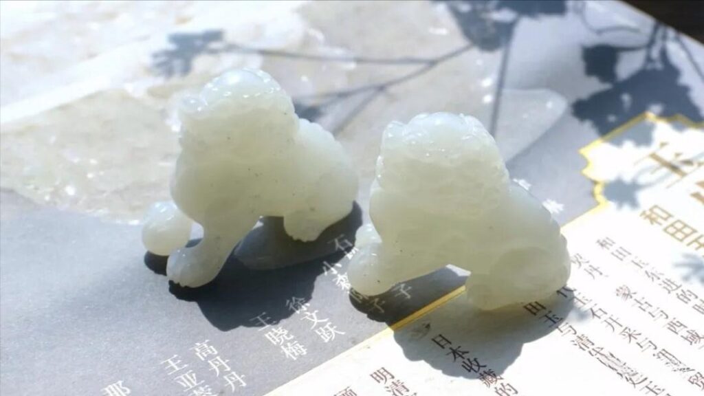 Authentic white Hetian Jade lion carvings by PeonyJewels, illustrating the quality and buttery luster of fine nephrite.