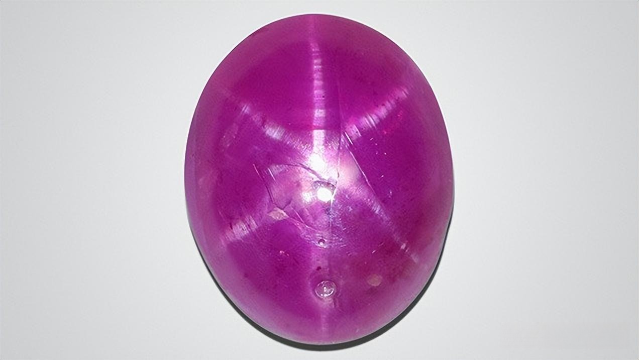 A Burmese Star Ruby gemstone treated with Bismuth Glass filling to enhance clarity and improve the visibility of the asterism (star effect).