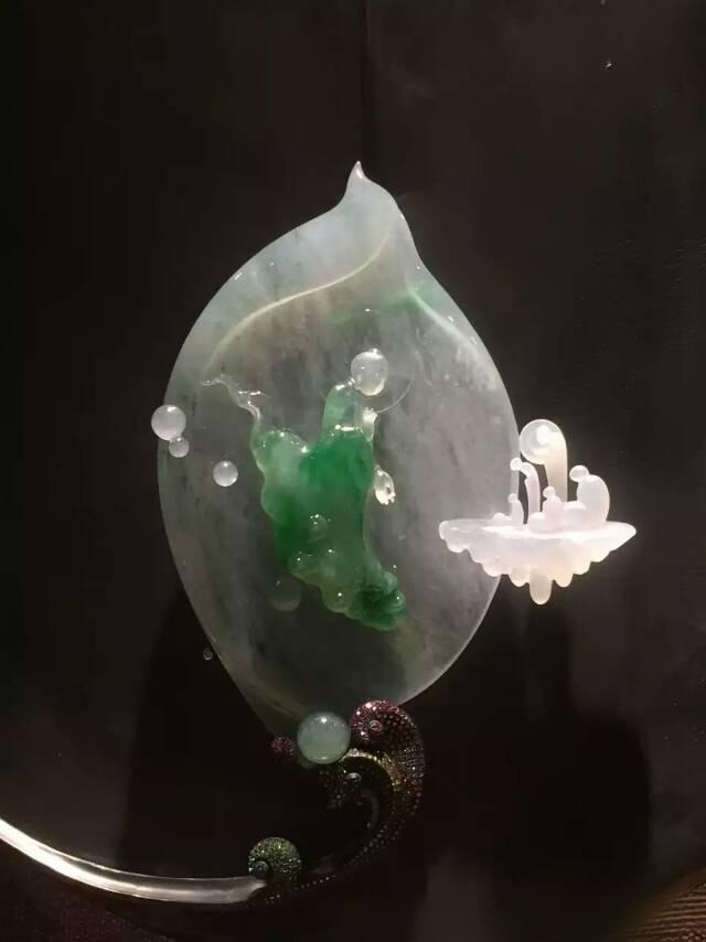 Computer-engraved jade ornament showing highly uniform, mass-produced patterns typical of machine carving.