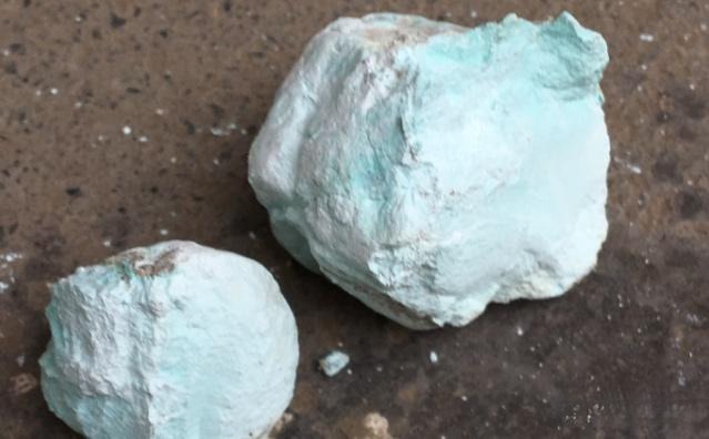 A dull, lusterless gemstone exhibiting color fading and loss of optical effects due to dehydration, illustrating the negative impact of water loss on mineral aesthetics.