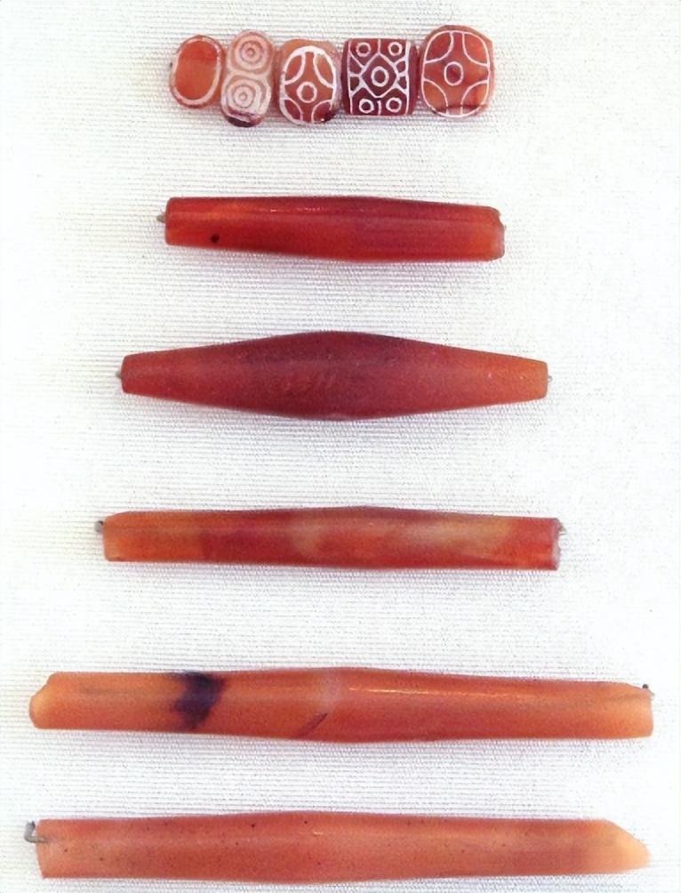 Various shaped etched beads from Indus Valley jewelry, each carrying unique cultural significance through their intricate patterns.
