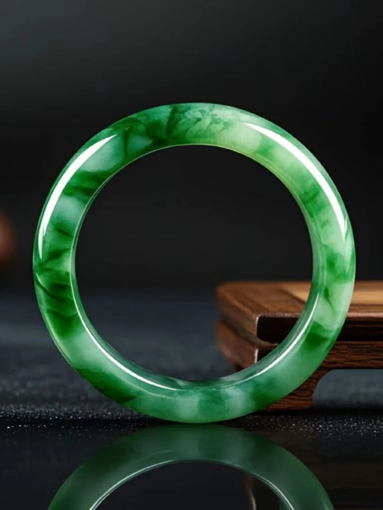 Dulong Jade Bangle - A unique Chinese gemstone, often called an "ice-glutinous green jadeite alternative," with natural green inclusions and quartzite structure.
