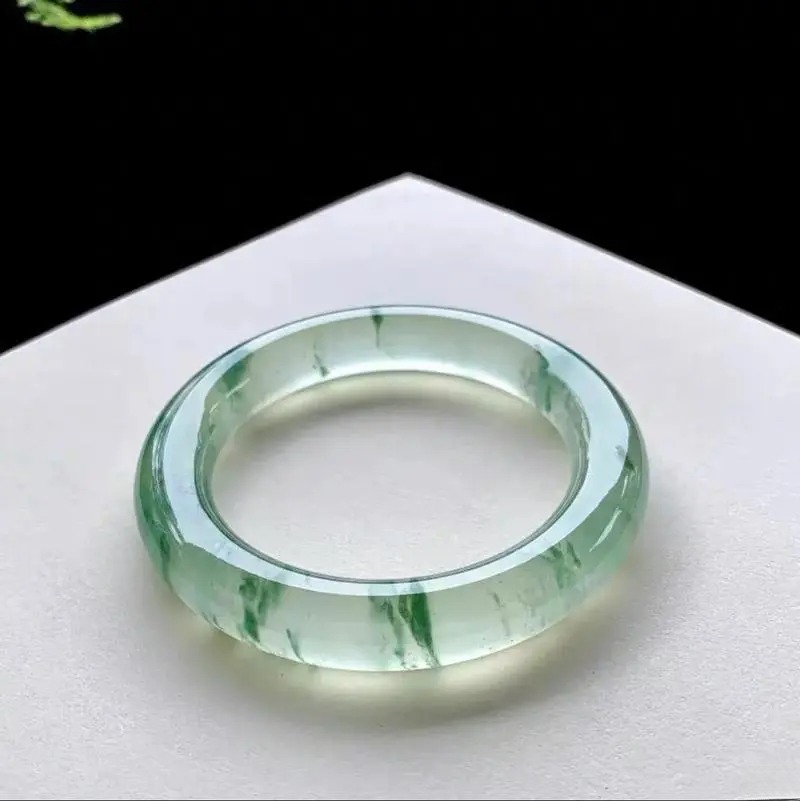 Dulong Jade bangle showcasing natural green tones and smooth polished surface.