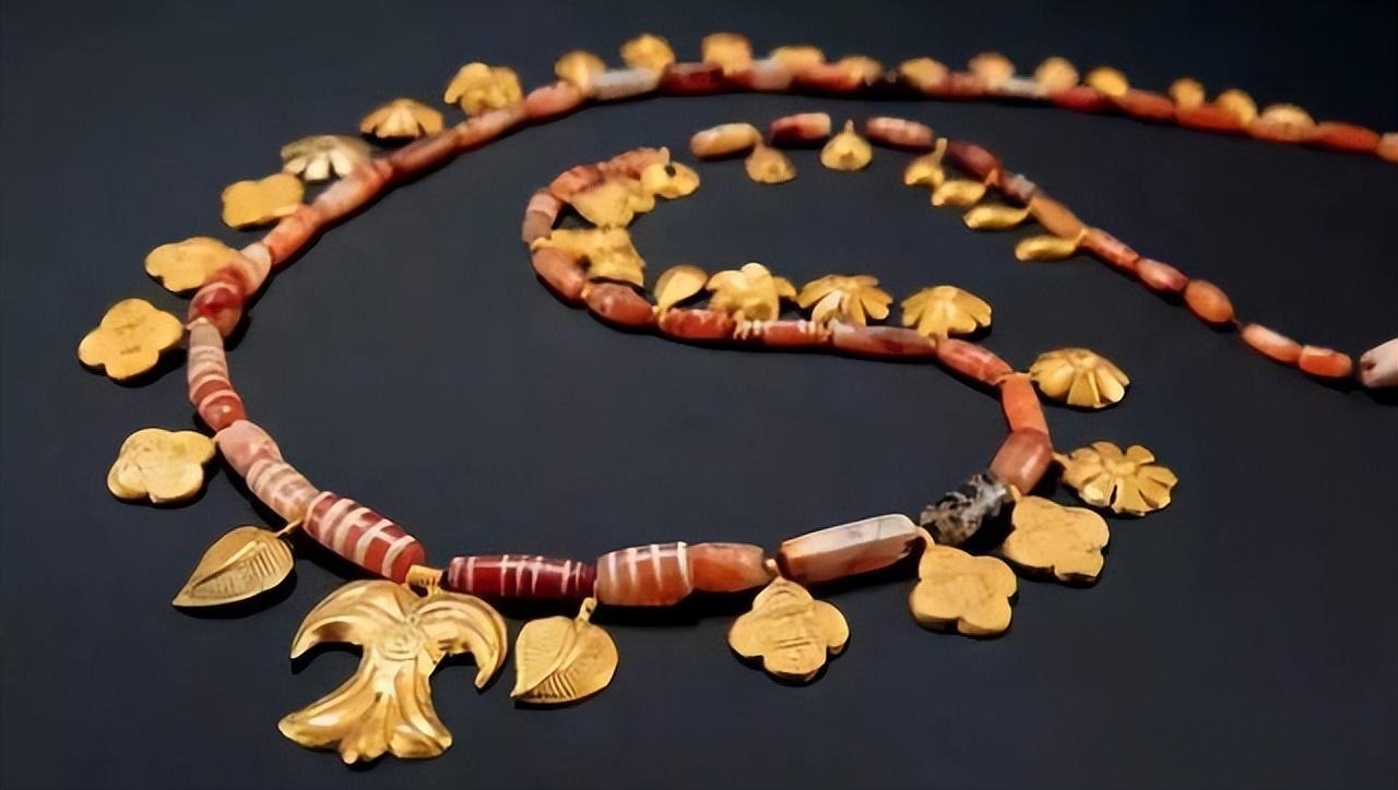 A necklace combining etched red agate beads with gold accents, blending intricate craftsmanship with luxury.