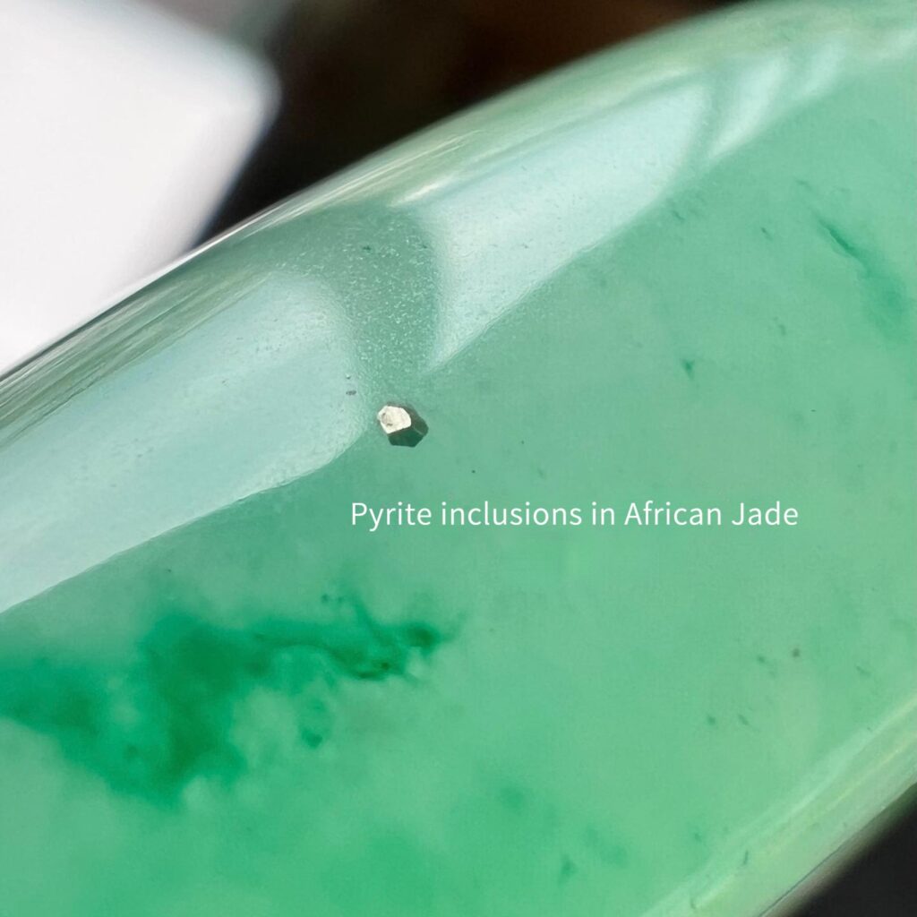 Close-up of a green quartzite bangle highlighting pyrite inclusions within the stone.