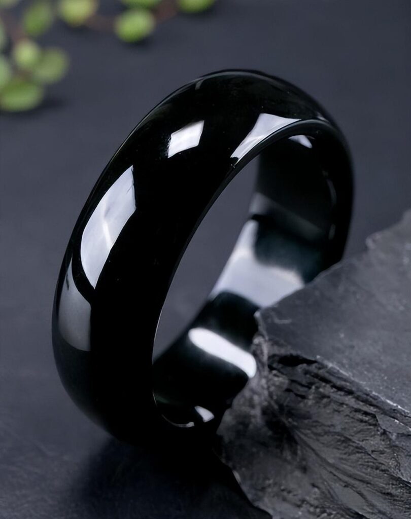 A black-green jade bangle from Guangxi ,that resembles certified Hetian Jade but contains high levels of secondary minerals (like hornblende), preventing it from receiving official nephrite certification.