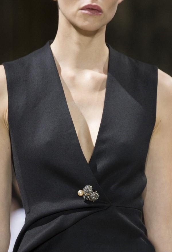 2017 Lanvin F/W model wearing a brooch at the center of the chest, seamlessly integrated as part of the outfit’s structure.
