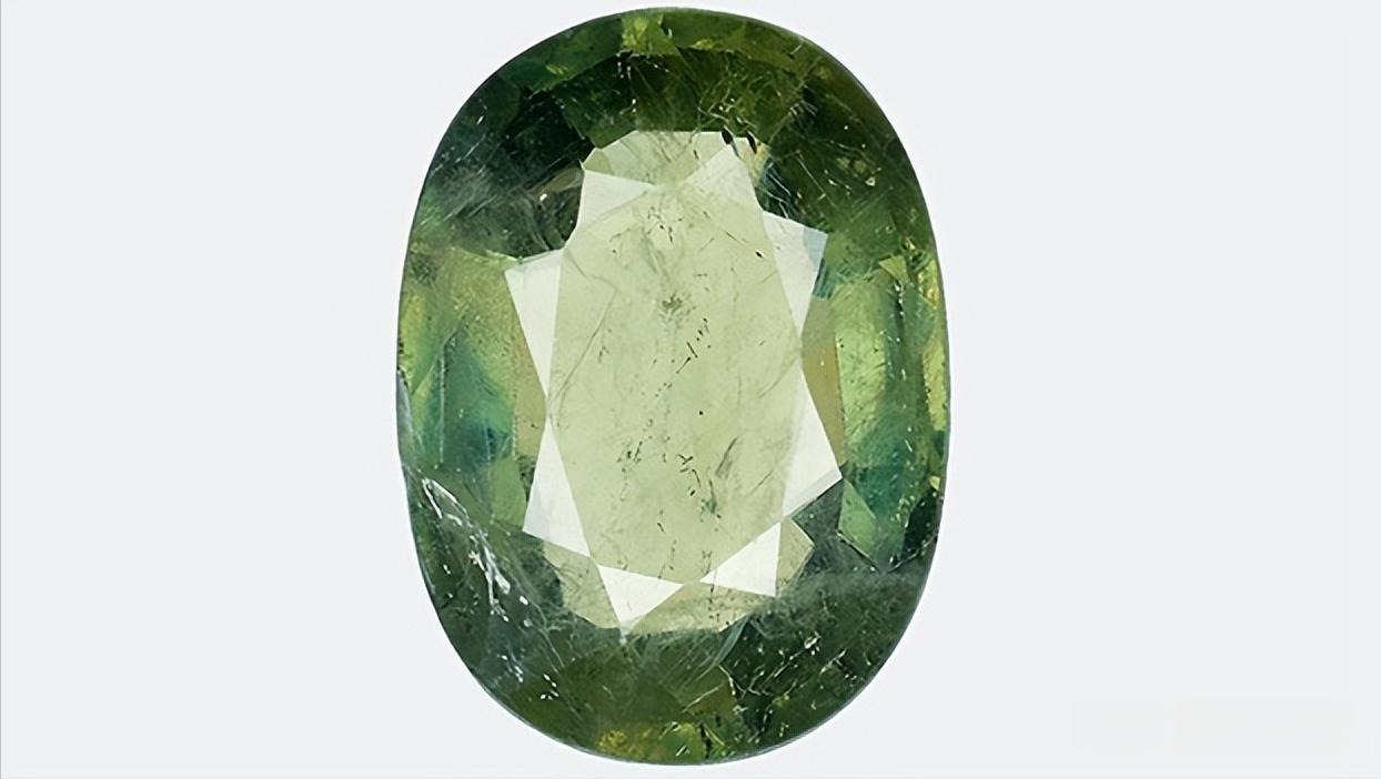 A green sapphire gemstone treated with lead glass filling to enhance its clarity and transparency.