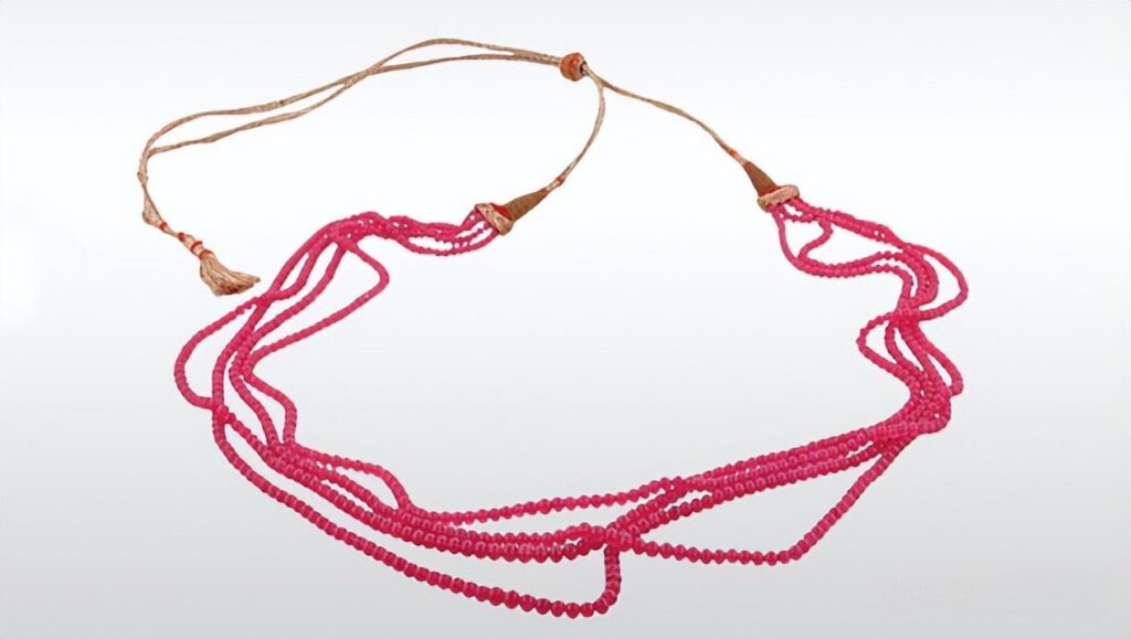 Lead glass filled ruby bead necklace, demonstrating the fracture filling treatment.