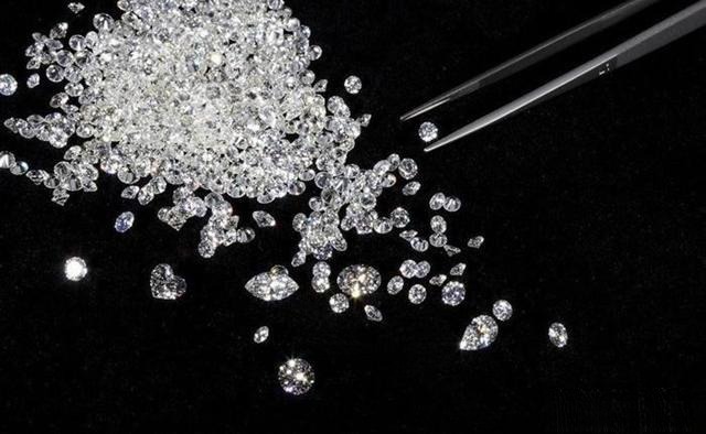 Collection of loose diamonds showing various sizes, clarity grades, and sparkle under light