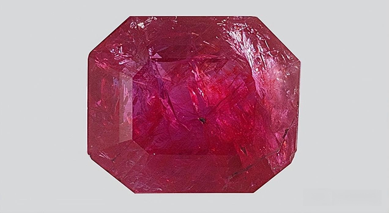 Image of a low-quality ruby showing the significant improvement in clarity and transparency achieved after fracture filling treatment.
