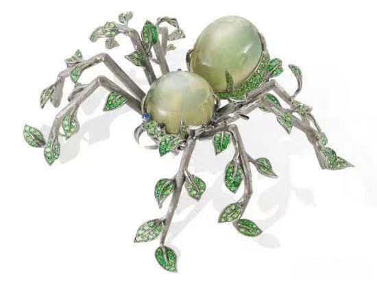 The striking Lydia Courteille spider brooch, featuring an Indian specialty gemstone—a vivid, parrot green Moonstone—as the body.