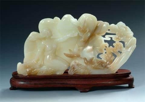 Carved ornament made from milky white Dushan Jade (Bai Du Yu), displaying the stone's characteristic opaque or semi-translucent sheen.