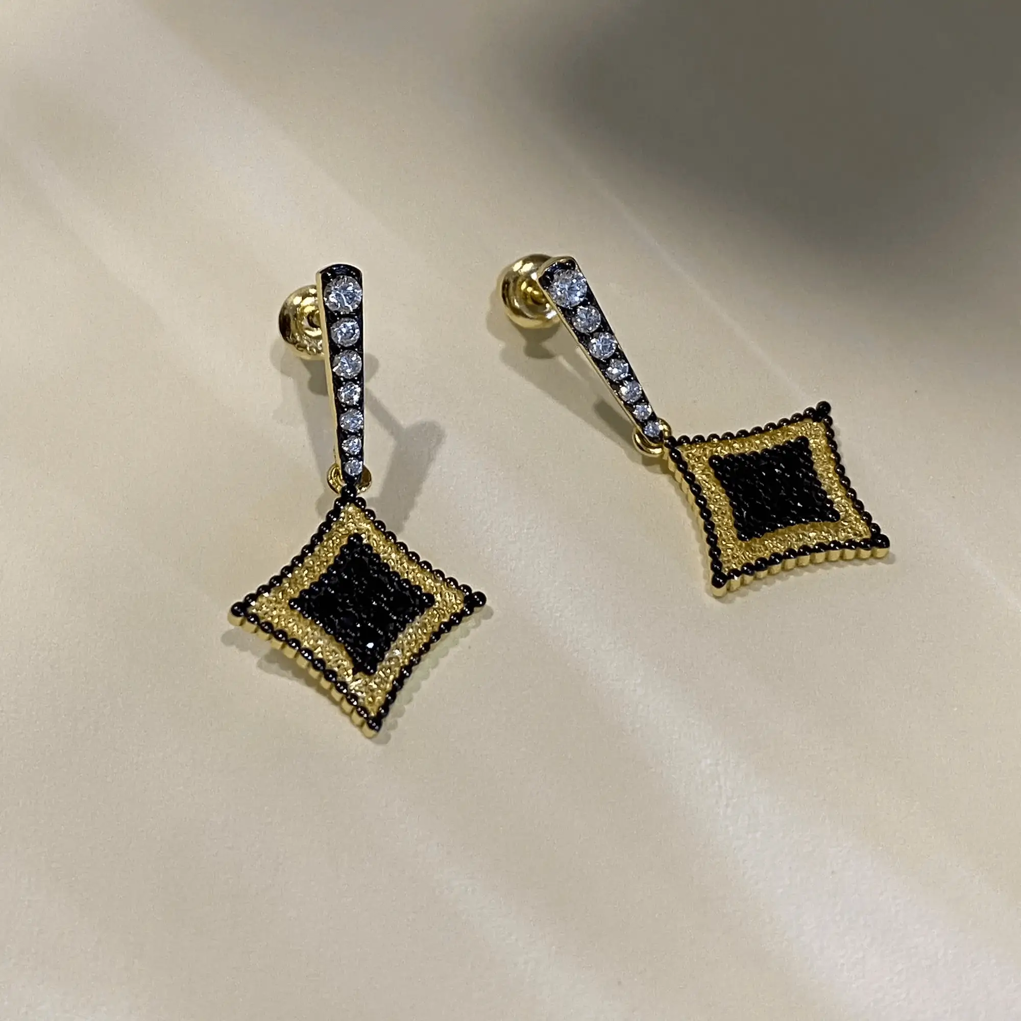 Minimalist 925 silver studs with vintage gold-tone finish, perfect for daily elegance.