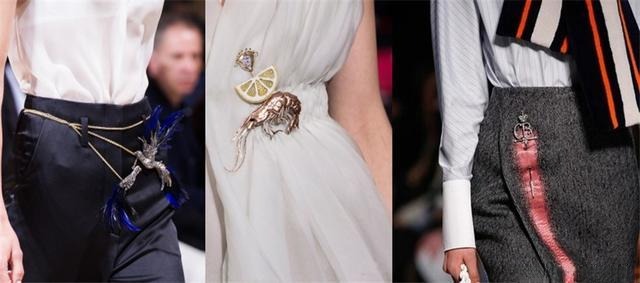Oversized brooch worn on the side of the waist, creatively linked with chains to form a decorative belt accent.