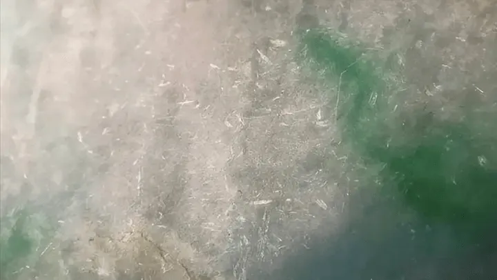Close-up of Peonyjewels jadeite bangle showing Cui Xing, bright reflective spots near stone flower areas