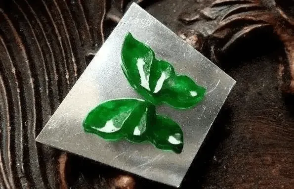 Jadeite butterfly carving showcasing skilled cutting and sculpting techniques, affecting appearance, translucency, and value – Jadeite Buying Guide.
