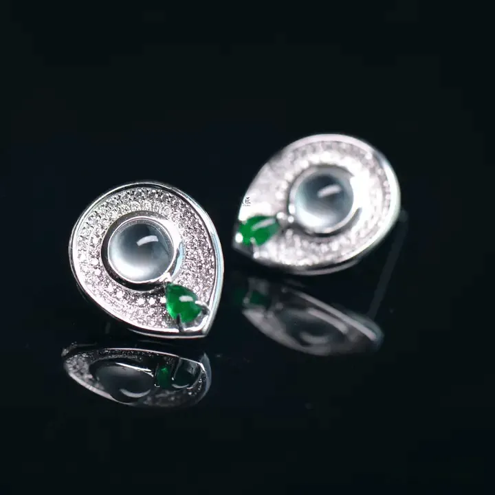 Peonyjewels jadeite earrings with double eyelid effect, sharp reflective edges on curved surface
