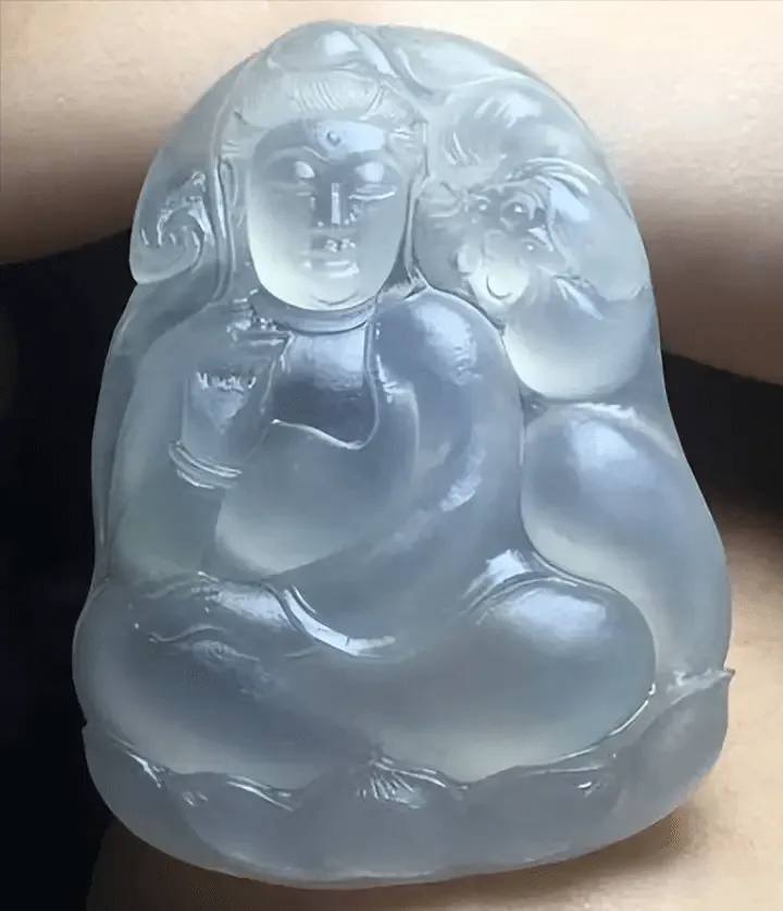 Jadeite Guanyin pendant in Mao Huo (rough) stage, partially carved but unpolished, with hidden minor fissures