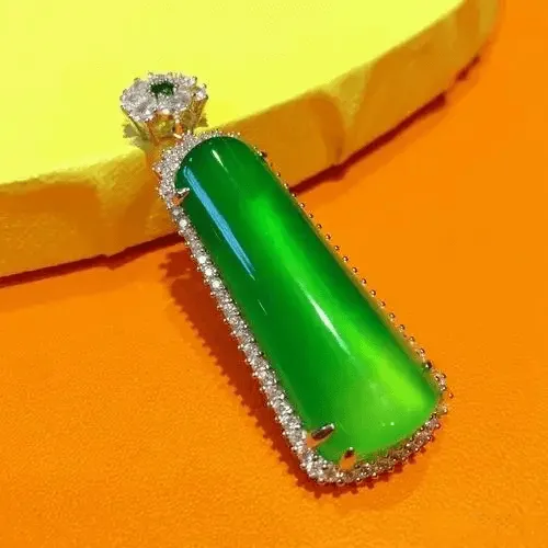 Peonyjewels jadeite pendant showing luminous glow on curved polished surface, translucent and radiant