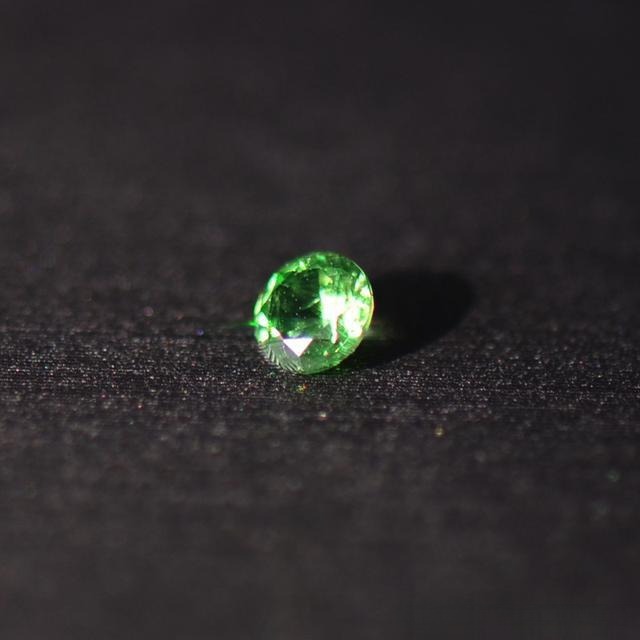 PeonyJewels' Russian Demantoid Garnet, featuring vivid color, used as an example of a high-quality semi-precious gemstone.