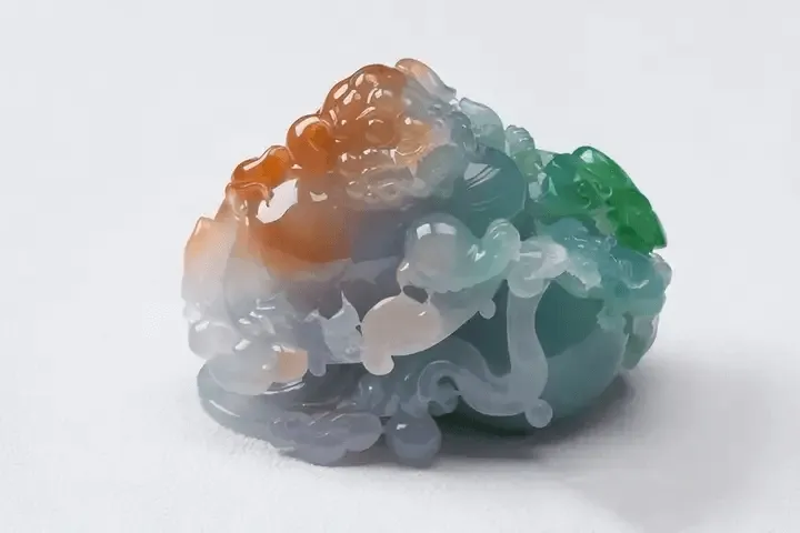 Three-color jadeite carving of Fu Lu Shou, showcasing green, yellow, and purple hues in high-quality jadeite – Jadeite Buying Guide.

