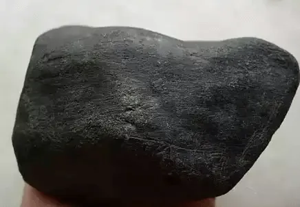 Jadeite rough with natural weathered skin formed by oxidation and surface changes, a key feature for assessing potential quality.