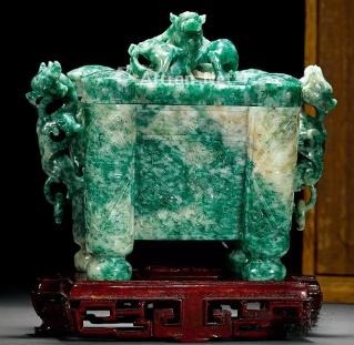 Qing Dynasty Dushan Jade censer with beast-head handles and movable rings, displaying mottled green and white colors.