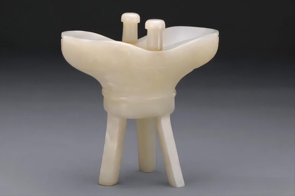 A historical Qing Dynasty ceremonial cup (Jue) carved from dense, high-quality Serpentine Jade (Xiuyu), highlighting the structural stability and artistry of the material when properly processed.