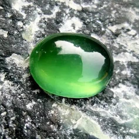 A rare specimen of Taishan Jade (Serpentinite) showing high translucency and a vibrant, sought-after green color.