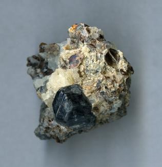 Rough Sapphirine gemstone with Mohs hardness of 7.5, demonstrating excellent durability and natural texture