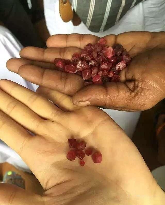 A Sri Lankan gem trader or dealer showcasing polished, faceted gemstones, highlighting typical market transactions and the quality on offer.