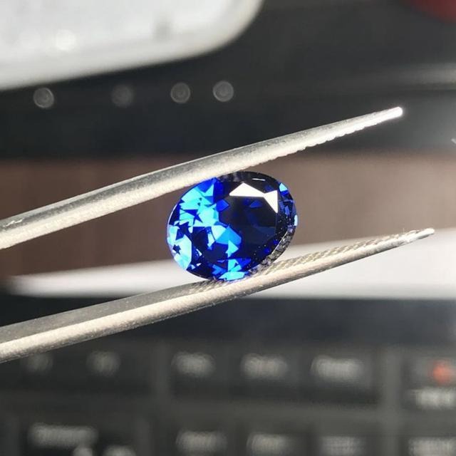 A synthetic blue sapphire cut stone, used to illustrate the common fake or man-made gems found in the market.