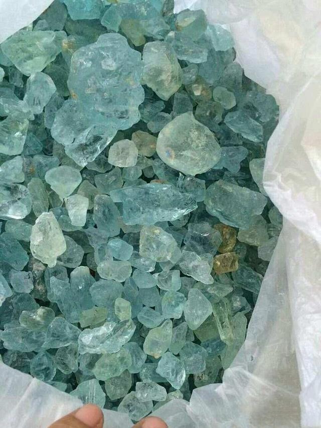 Untreated beryl rough from Xinjiang, China, displaying a natural pale bluish-green color due to the inherent yellowish tint before heating.
