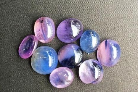 Vietnamese milky pink to purplish-pink sapphire, featuring soft tones and visible clear color zones, patches, and bands.