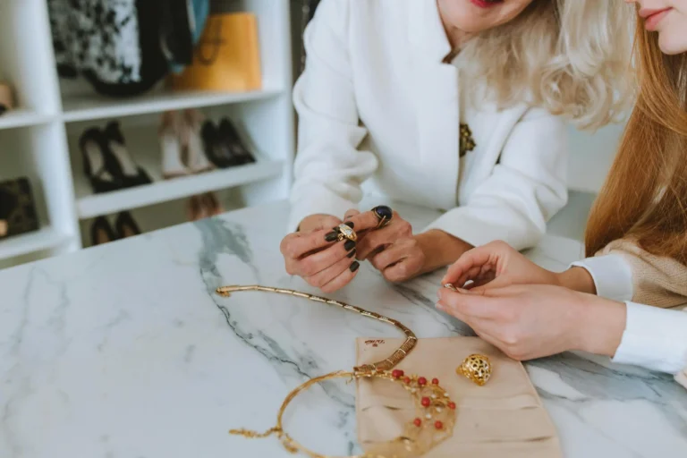Two women carefully inspecting cat’s eye gemstones in a boutique, representing the process of distinguishing real vs fake Sri Lankan cat’s eye jewelry.