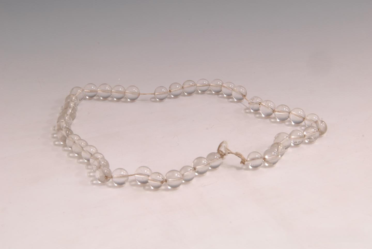 An ancient Chinese crystal artifact: a Yuan Dynasty crystal bead necklace, flawless, pure, and translucent, showcasing exceptional craftsmanship and perfect clarity.