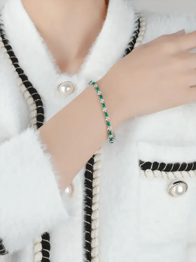 A custom-designed PeonyJewels bracelet featuring natural emeralds set in 18k gold with accent natural diamonds.