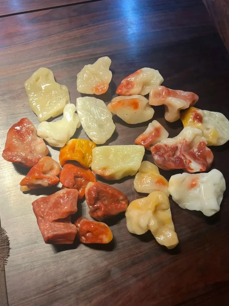 a collection of shoushan furong stones in white, yellow, and red.