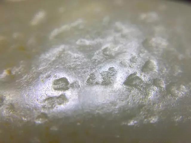 Close-up of Xinjiang Hetian Ziyu showing coarse, rough pores typical of 'dry seed' (han zi) or 'dry pit material.'